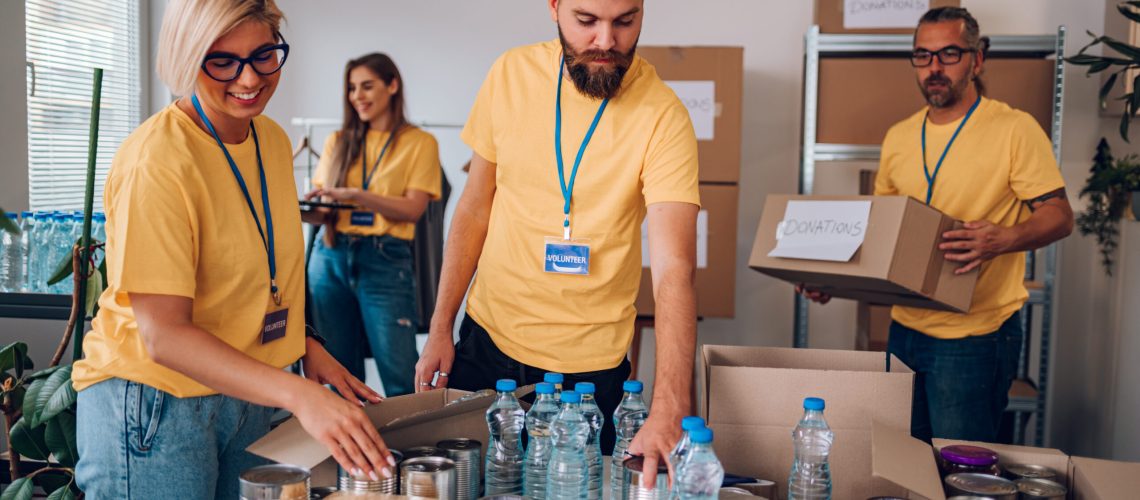 Group of volunteers working in community charity donation center